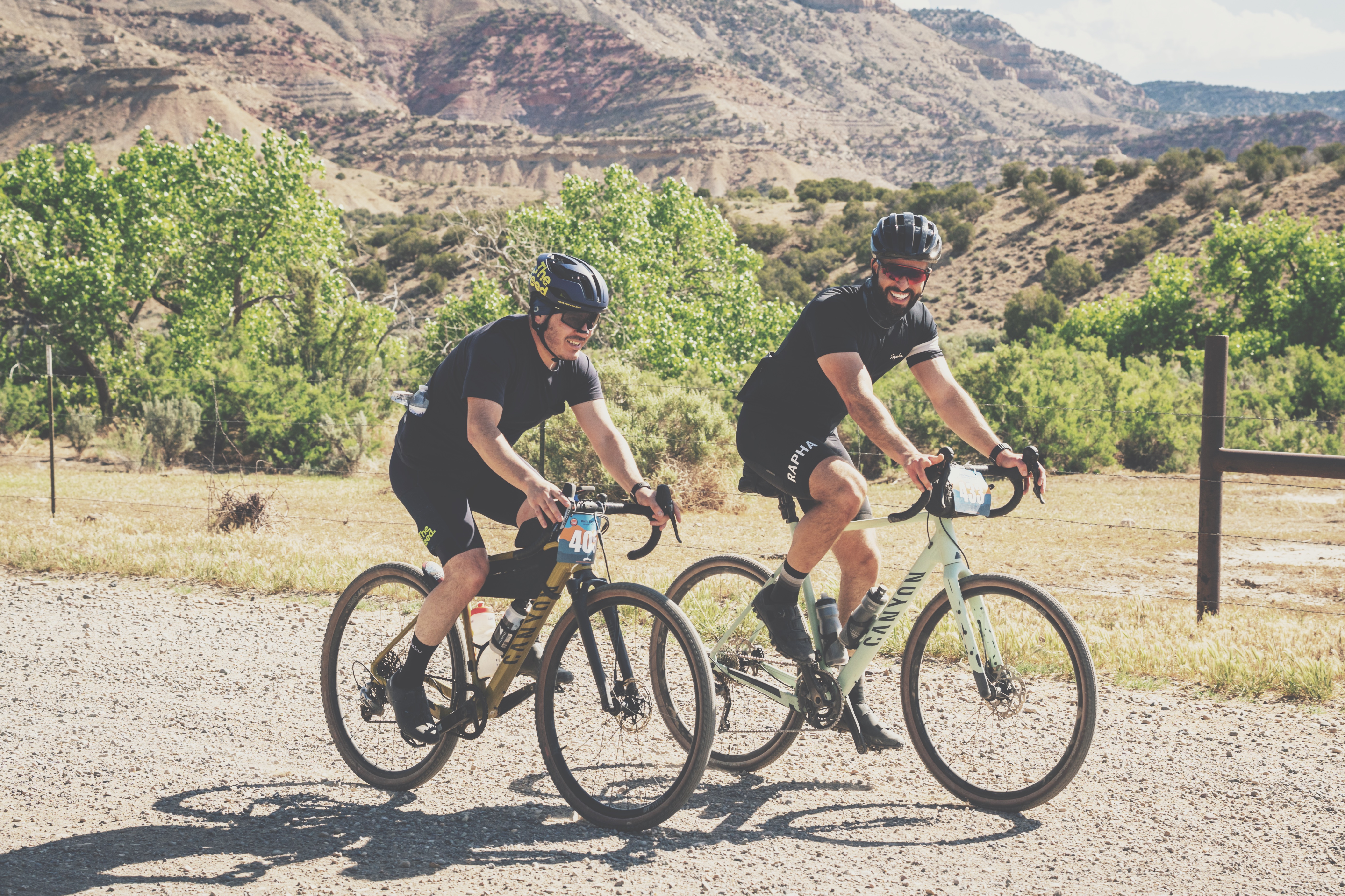 Two cyclists riding gravel together